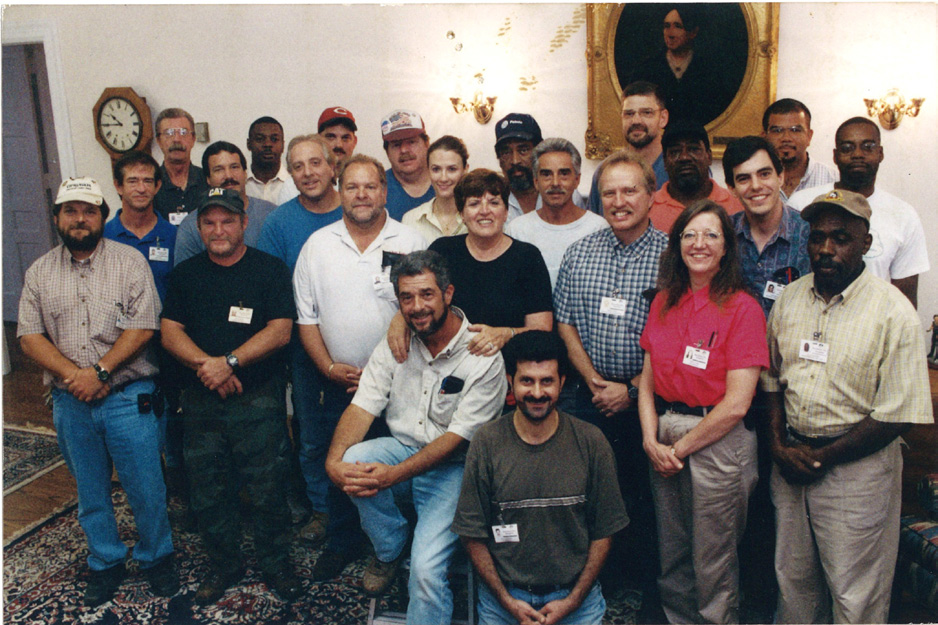 The Dix crew in the living room with Community Relations director Faye McArthur after completion of renovations in 2002.
