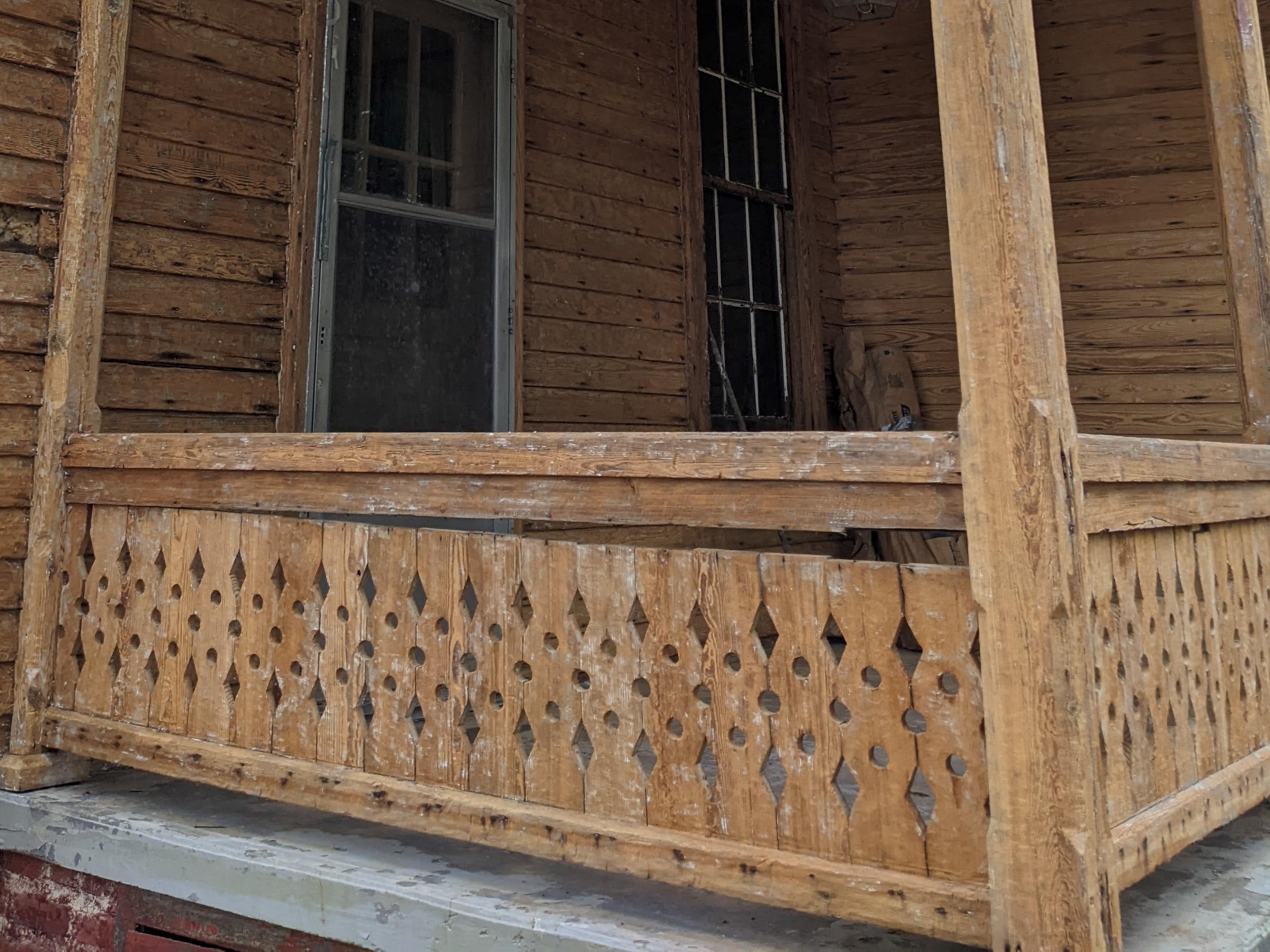 House of Many Porches back porch after abatement showing the original balustrade ca. 2023