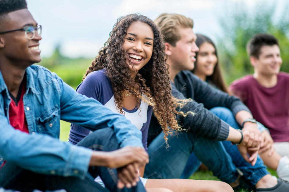 Diverse group of teens sitting outside