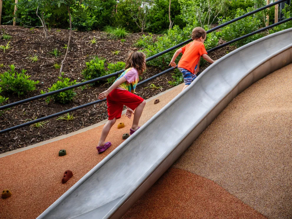 kids running up a slide