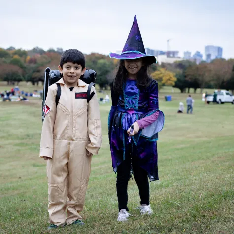 Two kids in costume at Movies on the Lawn Halloween 2022