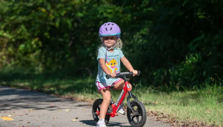 Child on balance bike on the greenway
