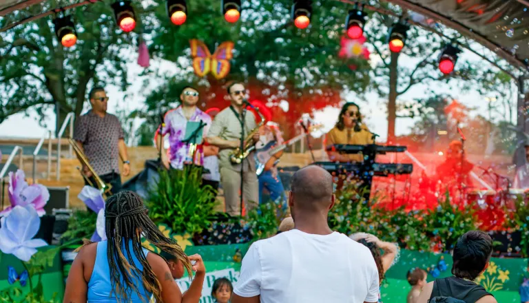Gipson Play Plaza Opening Event People watching live music on stage