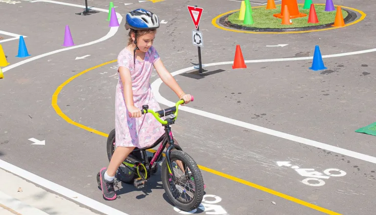 Girl riding her bike in the traffic garden at Dix Park