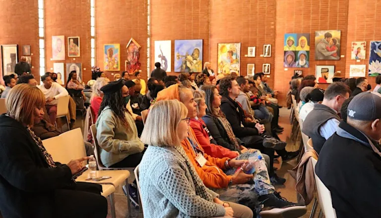 Audience at an artist talk in the Dix Park Chapel