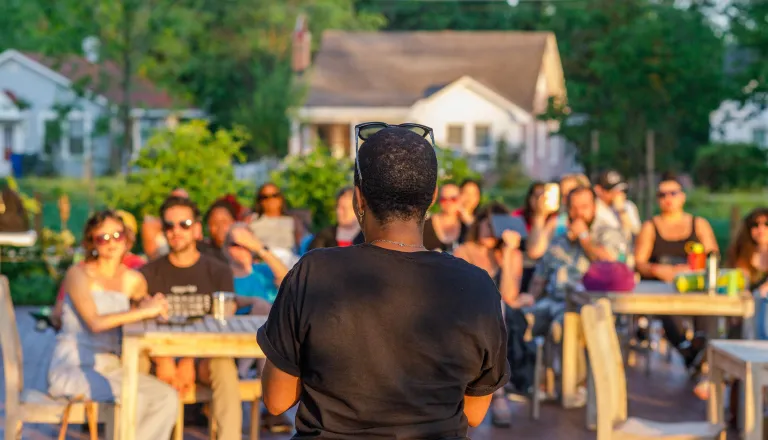 Person reading to a crowd