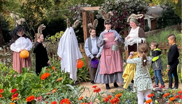 People dressed in costumes performing theater outside.