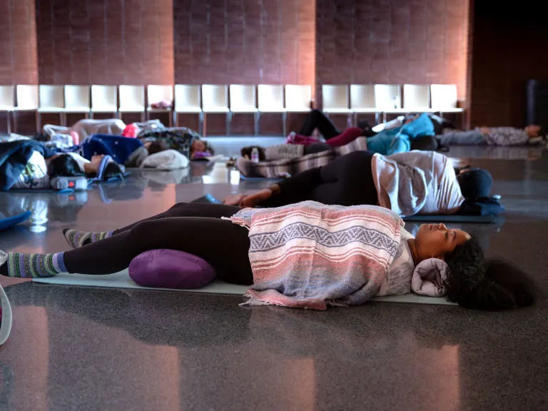 Sound Bath participant lying in the Dix Park Chapel
