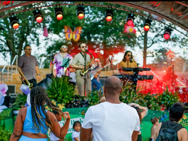 Gipson Play Plaza Opening Event People watching live music on stage