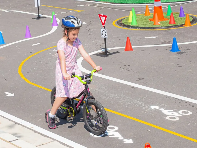 Girl riding her bike in the traffic garden at Dix Park
