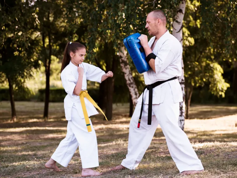 Parent and child taekwondo outdoors