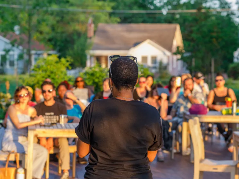 Person reading to a crowd