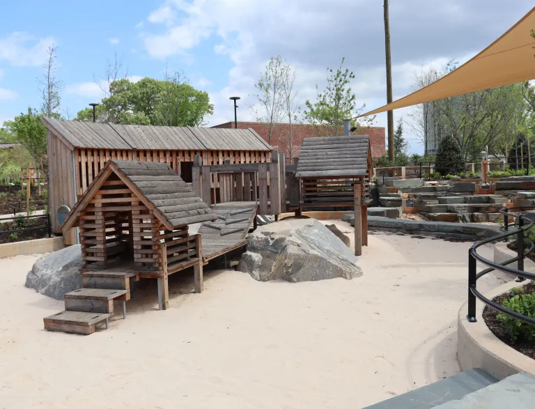 Sand Bowl and Boulder Town wooden play houses and sand play area at Gipson Play Plaza