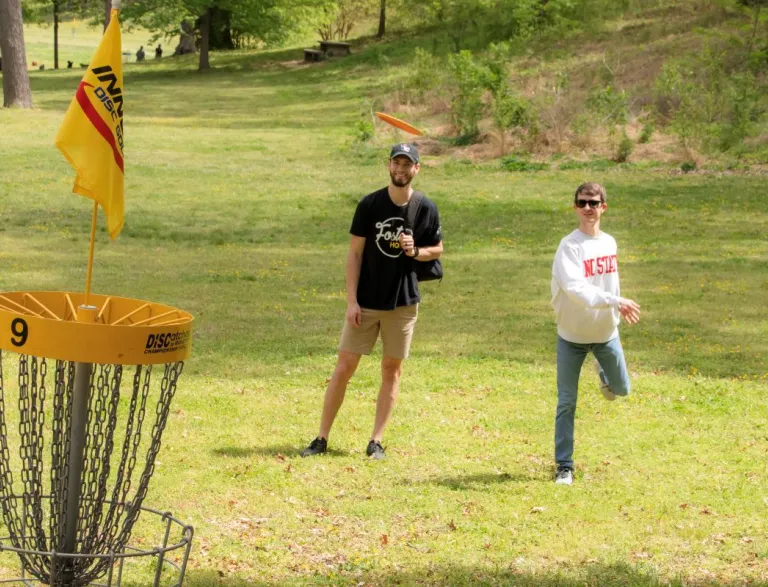 Two Disc Golf players putting