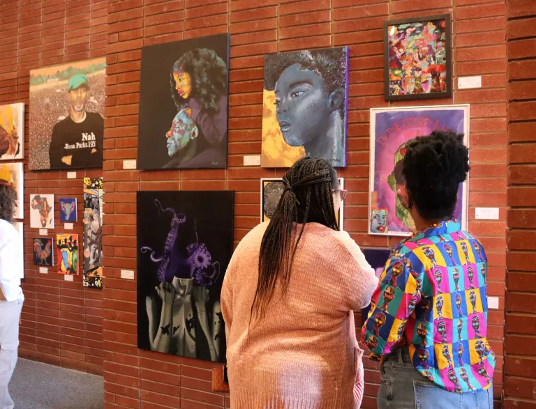 People visiting the 2024 Living In Color exhibit in the Chapel