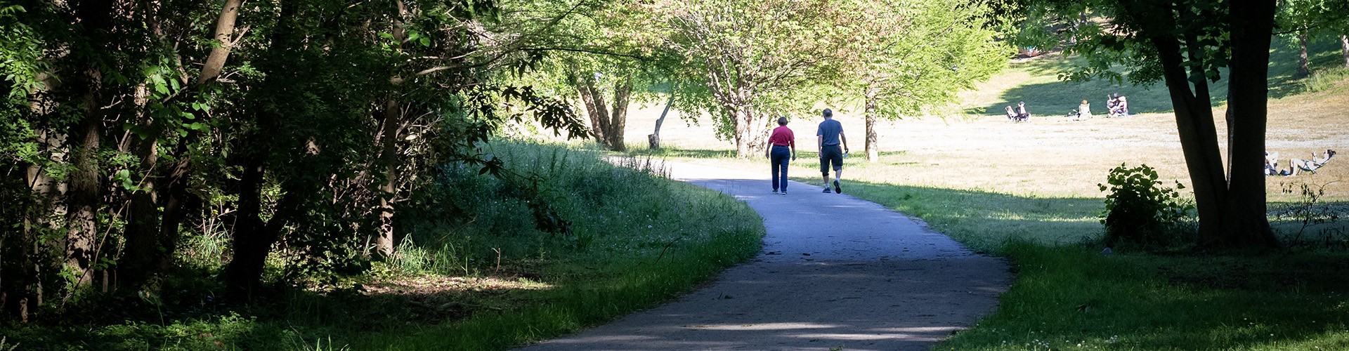 Two people walking on the Rocky Branch Greenway